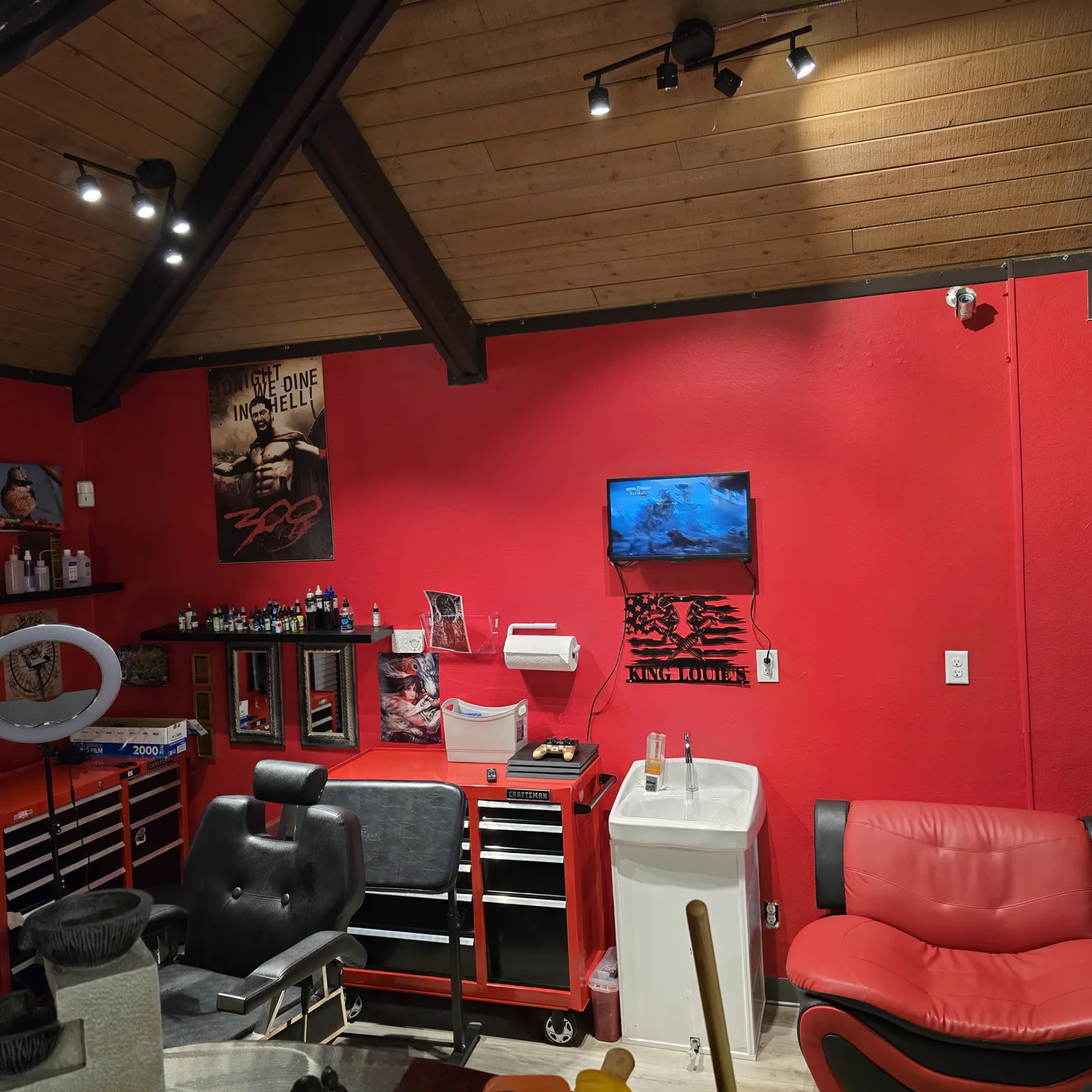 Inside King Louie's Tattoo Parlor — tattoo station and lounge